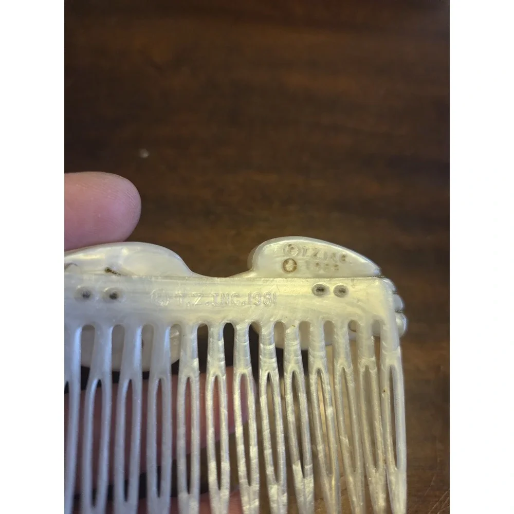 T.Z. Inc. 1981 vintage hair comb is made of faux mother-of-pearl cellulose...